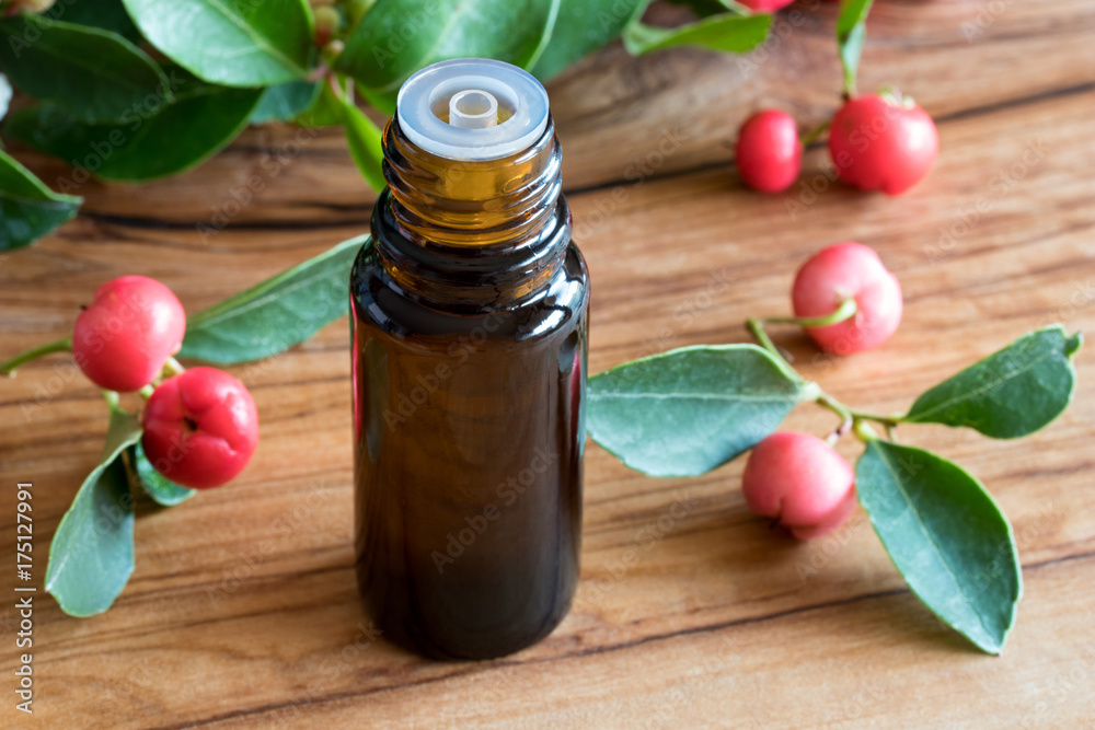 A bottle of wintergreen essential oil on a wooden background