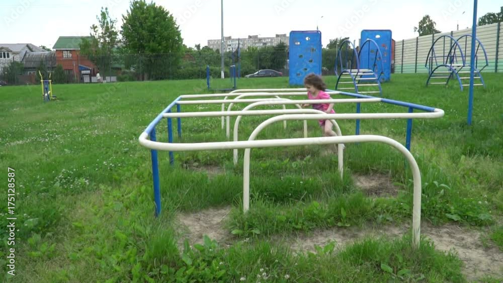 The little girl is at the gym under the open sky The little girl is at the gym under the open sky