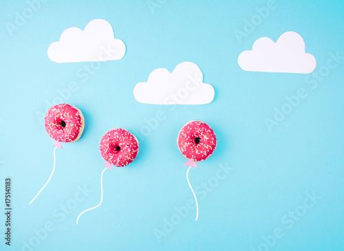 Donut covered with icing on blue background.