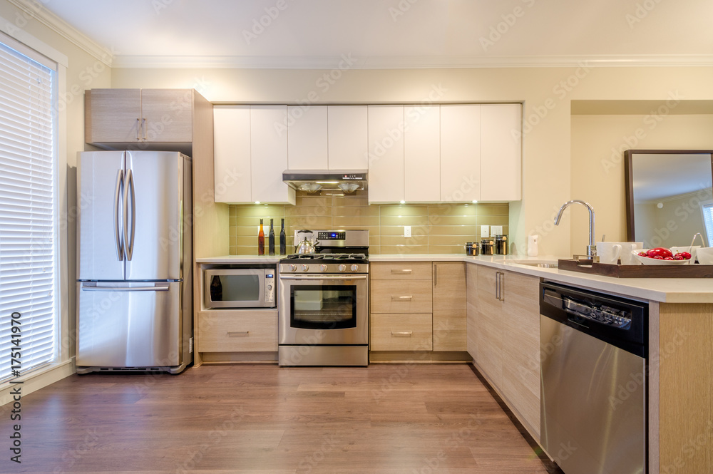 Modern, bright, clean, kitchen interior with stainless steel appliances in a luxury house. Modern, bright, clean, kitchen interior with stainless steel appliances in a luxury house.