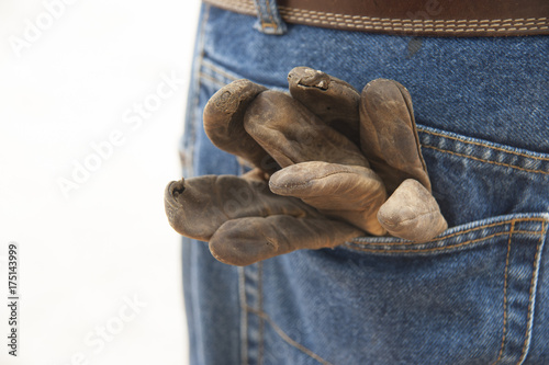 Leather work gloves in back denin jeans pocket photo