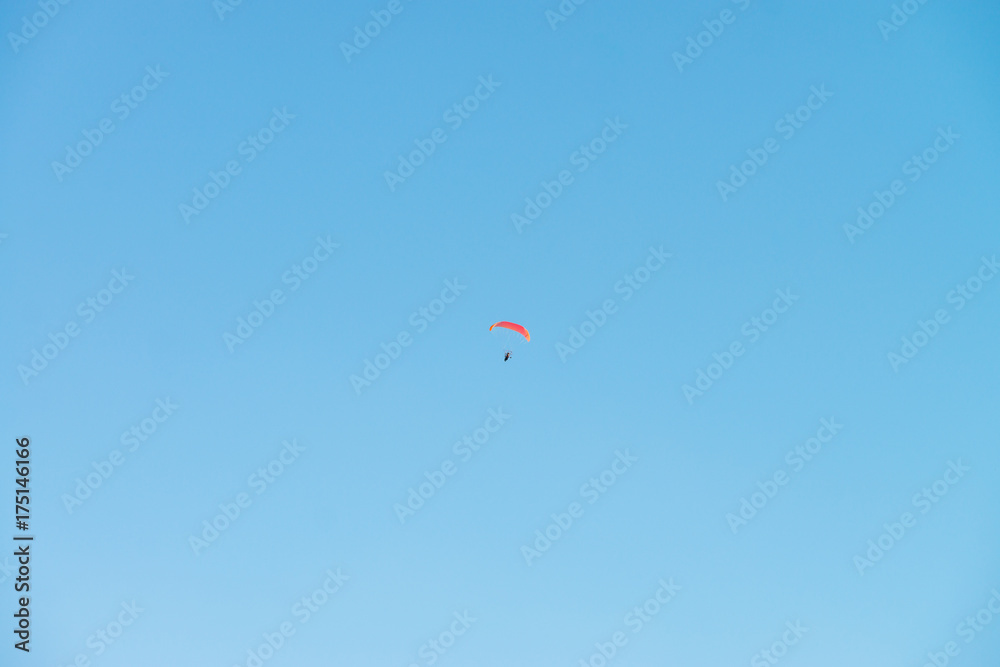 Paraglider in blue sky. Minimalistic style. Paraglider in blue sky. Minimalistic style.