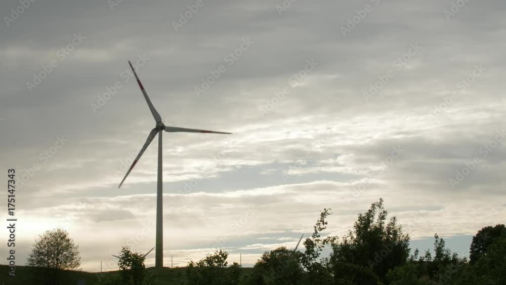 Wind turbine farm, electric power generators, on field on cloudy sky background. Renewable energy production. Wind turbine farm, electric power generators, on field on cloudy sky background. Renewable energy production.