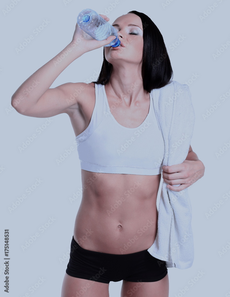 happy smiling woman in sportswear drinking water, isolated over white background happy smiling woman in sportswear drinking water, isolated over white background