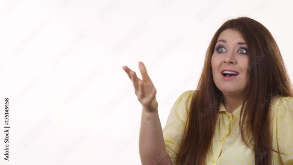 Shocked and surprised young woman pointing with finger at copy space. Face expression, human emotions. Advertisement concept. 4K ProRes HQ codec Shocked and surprised young woman pointing with finger at copy space. Face expression, human emotions. Advertisement concept. 4K ProRes HQ codec