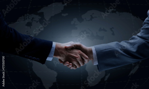 Handshake with map of the world in background #175150700