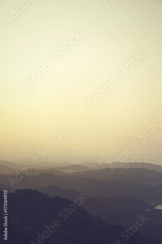 Landscape of nature mountain terrain hills layered in silhouette shade - with copy space - in portrait view orientation