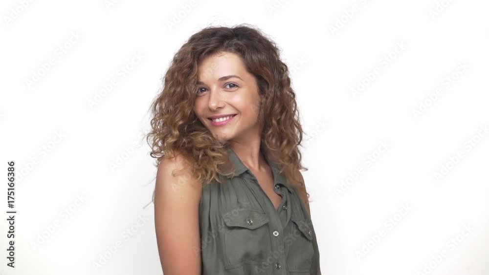 in slow motion adorable attractive woman playing touching her nice hair admiring herself isolated over white background. Concept of emotions