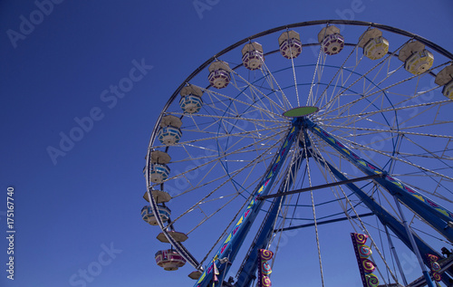 Isolated Upward Frontal View of Ferris Wheel Against Deep Blue Sky
