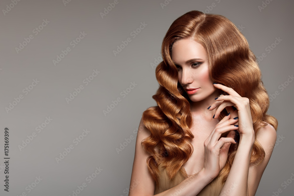 Fototapeta premium Portrait of woman with long curly beautiful ginger hair.