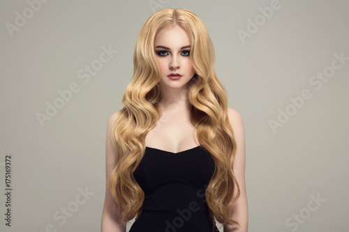 Blond woman with long curly beautiful hair.