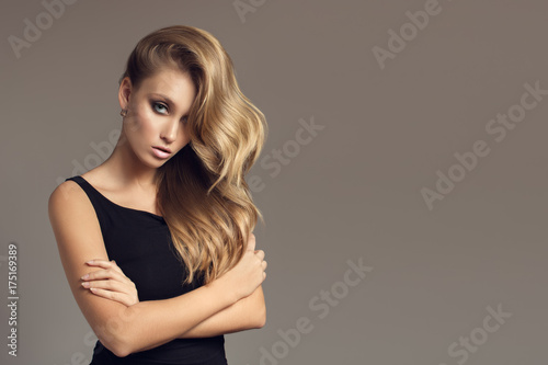 Blond woman with long curly beautiful hair.