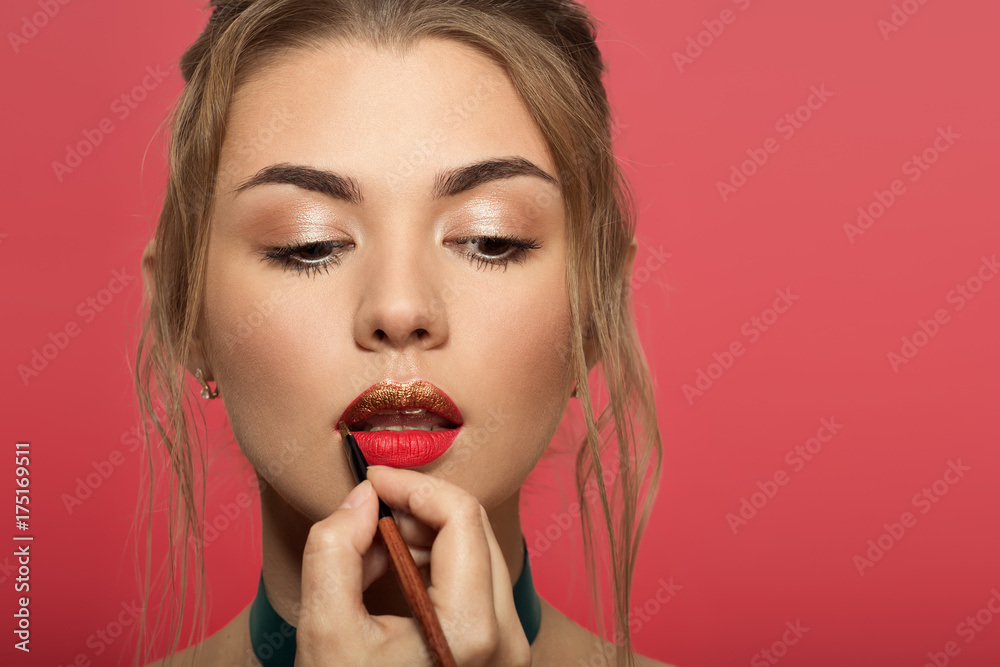 Portrait of beautiful woman with bright make up. Liquid golden lipstick. Portrait of beautiful woman with bright make up. Liquid golden lipstick.
