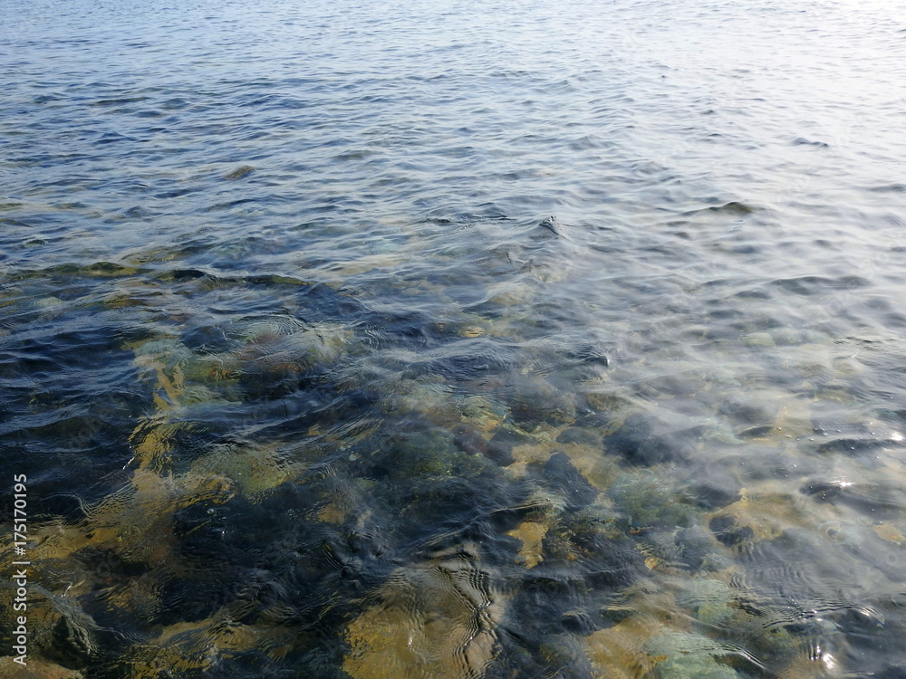 Beach background / A beach is a landform along a body of water. It usually consists of loose particles, which are often composed of rock, such as sand, gravel, shingle, pebbles