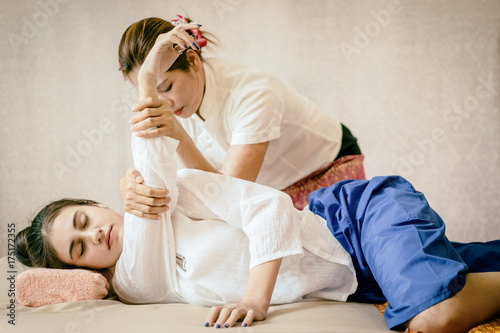 Women is getting Thai Massage Spa stretching