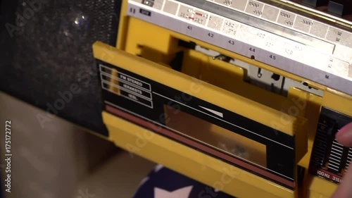 girl inserts a tape in the recorder