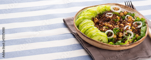 Quinoa salad bowl with cucumbers, chickpeas, onions, arugula. Light protein healthy dinner lunch