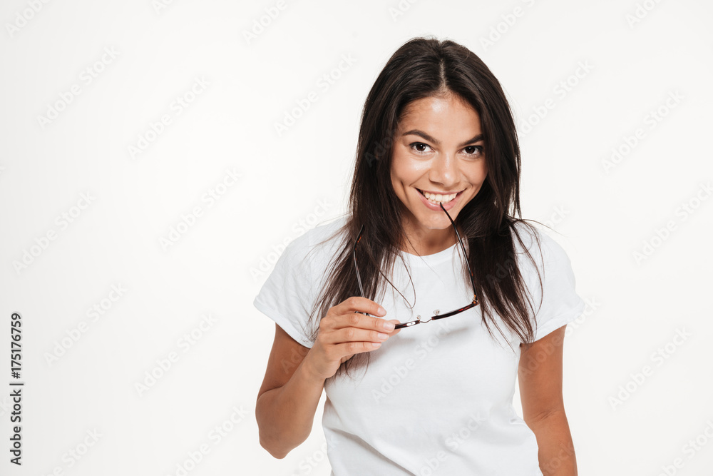 Portrait of a woman holding sunglasses and looking at camera Portrait of a woman holding sunglasses and looking at camera