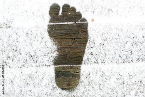The imprint of the Barefoot feet on snow