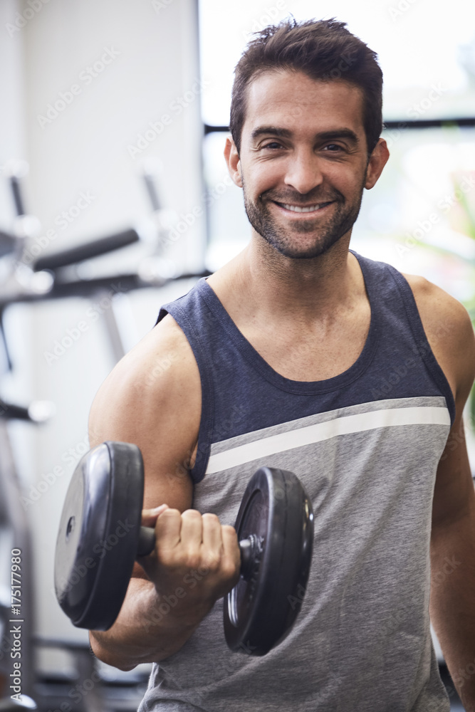 Bicep curl guy in vest in gym, portrait Bicep curl guy in vest in gym, portrait