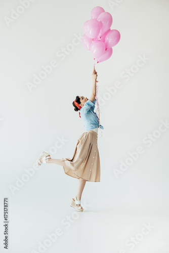 asian woman holding balloons