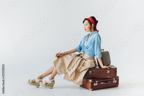 asian woman sitting on luggage