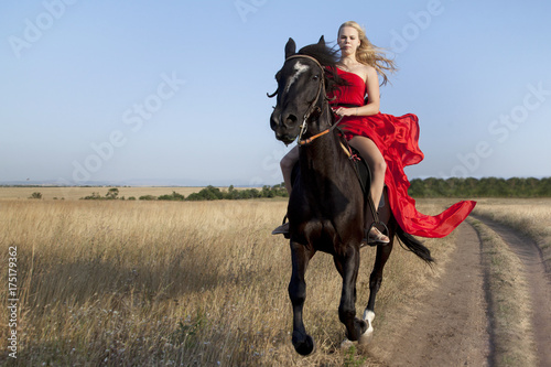 Tablou canvas Horse run gallop and girl rider sitting in the saddle