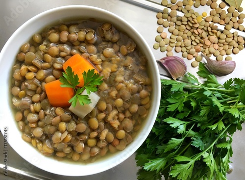 Legumes soup. Vegetable lentils soup with carrot, celery and parsley. Top view.