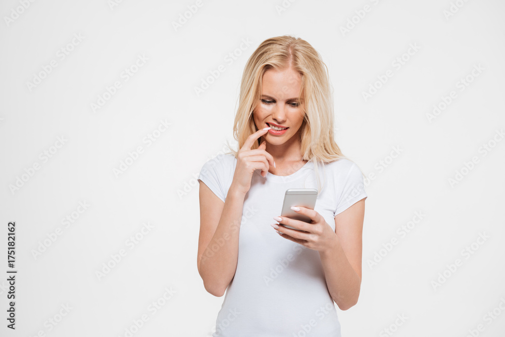 Portrait of a thoughtful blonde woman using mobile phone Portrait of a thoughtful blonde woman using mobile phone