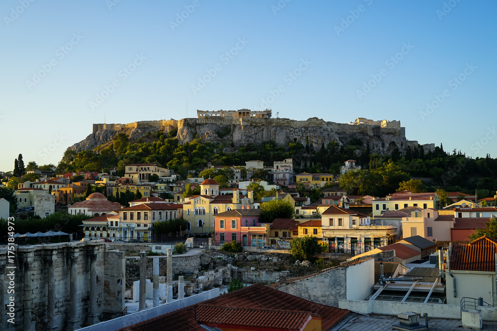 View of the Acropolis, Erechtheion, from Monasteraki Square through old town buildings and Hadrian's Library ruins