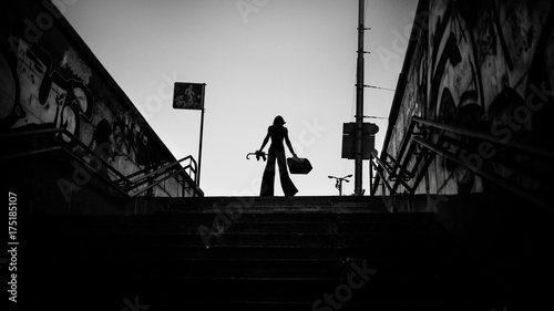 Fashion art portrait of elegant girl in geometric. Black and white photo of stylish young woman in cityscape