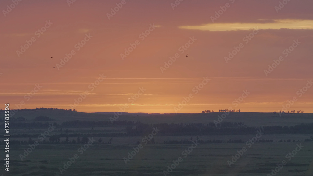 Natural Sunrise Over Field Or Meadow. Bright Dramatic Sky And Dark Ground. Countryside Landscape Under Scenic Colorful Sky At Sunset Dawn Sunrise. Sun Over Skyline, Horizon. Warm Colours
