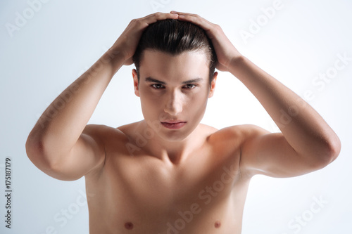 Handsome brunette smoothing his hair