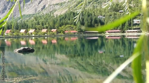 Reflection Of Flora On Water Source In Front Of Temple And Moutains - Pan - Left To Right  photo