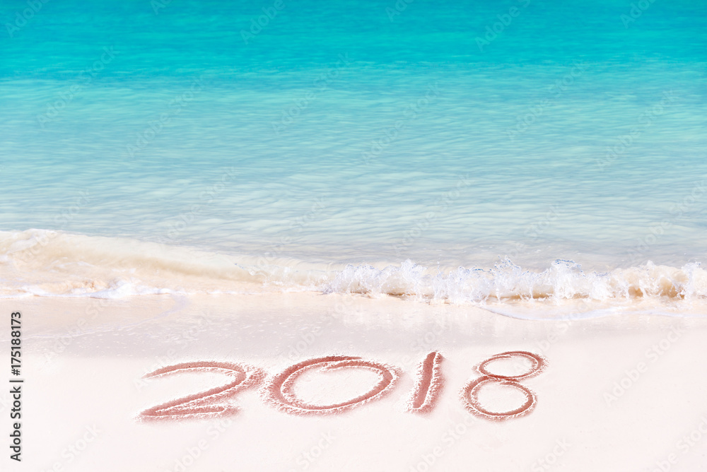 2018 written on the sand of a beach, travel 2018 new year concept 2018 written on the sand of a beach, travel 2018 new year concept