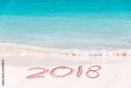 2018 written on the sand of a beach, travel 2018 new year concept