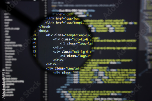 Real Html code developing screen. Programing workflow abstract algorithm concept. Lines of Html code visible under magnifying lens.