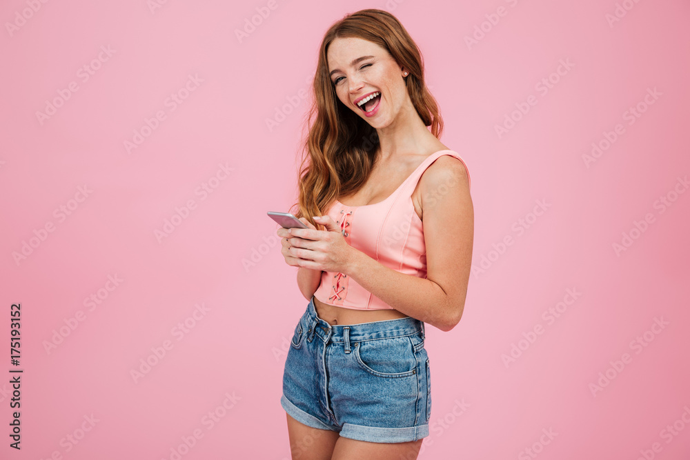 Portrait of a girl in summer clothes holding mobile phone
