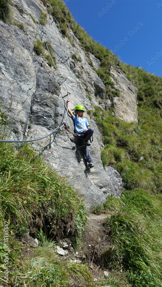 Young girl - children climbing on via ferrata Young girl - children climbing on via ferrata