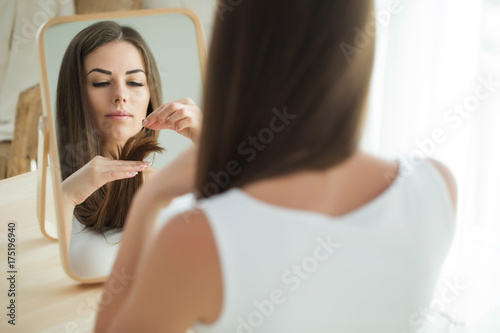 A woman is cutting her hair 