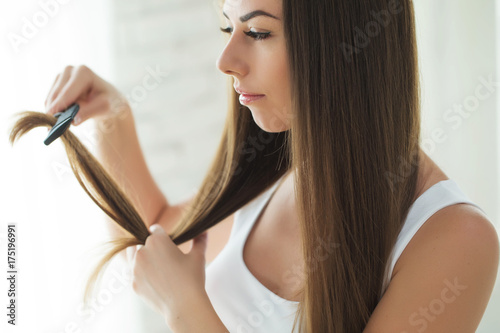 Woman combing her hair 