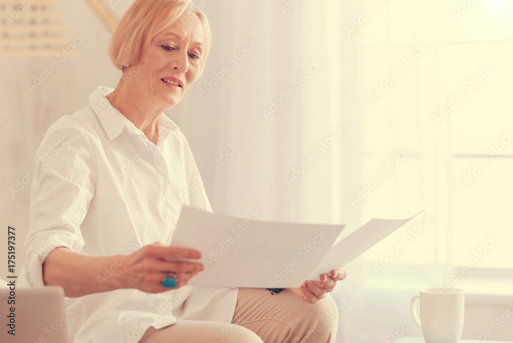 Nice aged woman holding papers Nice aged woman holding papers