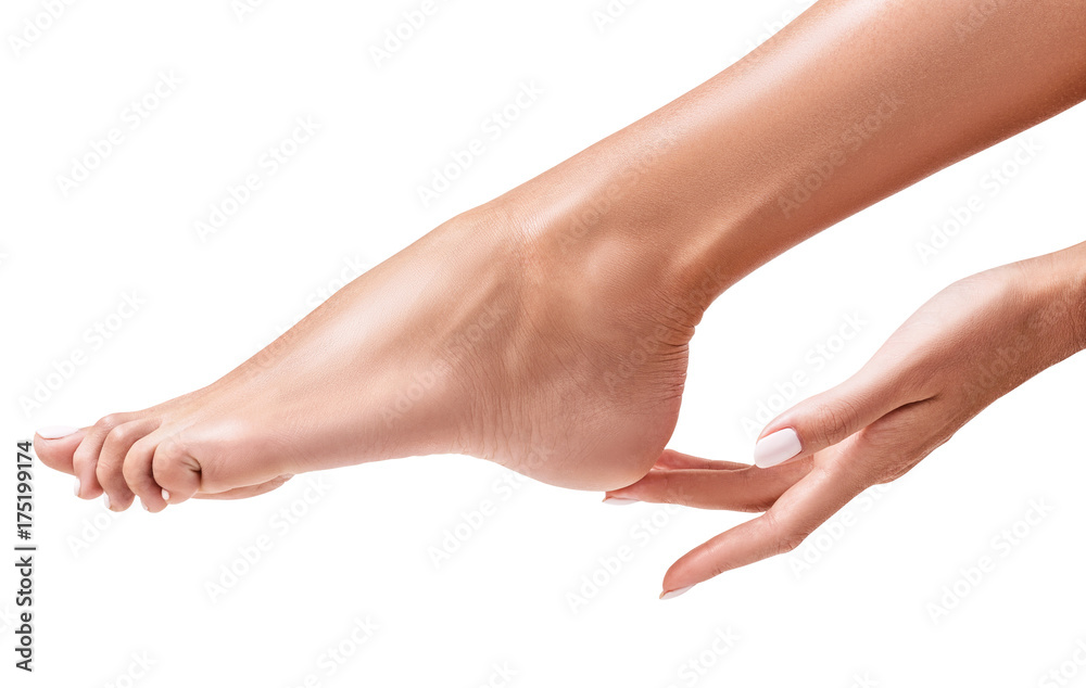 Photo Perfect female feet. Hand touches elegant leg.