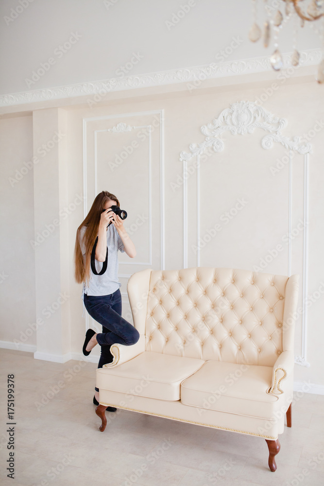 Woman photographer taking a shoot in a studio Woman photographer taking a shoot in a studio