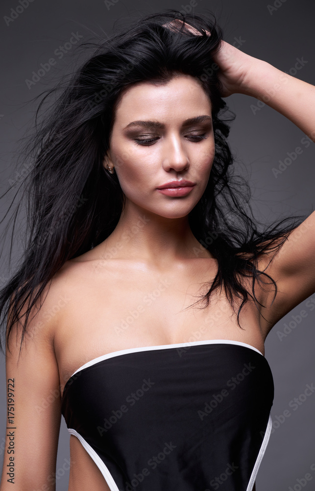 Portrait of a young brunette woman with long black streaming hair Portrait of a young brunette woman with long black streaming hair