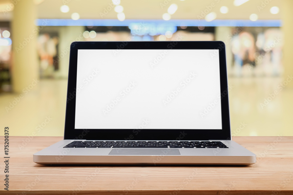 Computer with white screen on table with blur background. Technology concept.