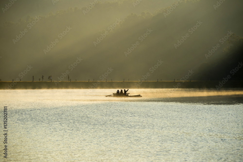 Beautiful silhouette morning with bamboo raft for touring at Pang Ung Lake the famous place of Mae Hong Son province, North of Thailand.