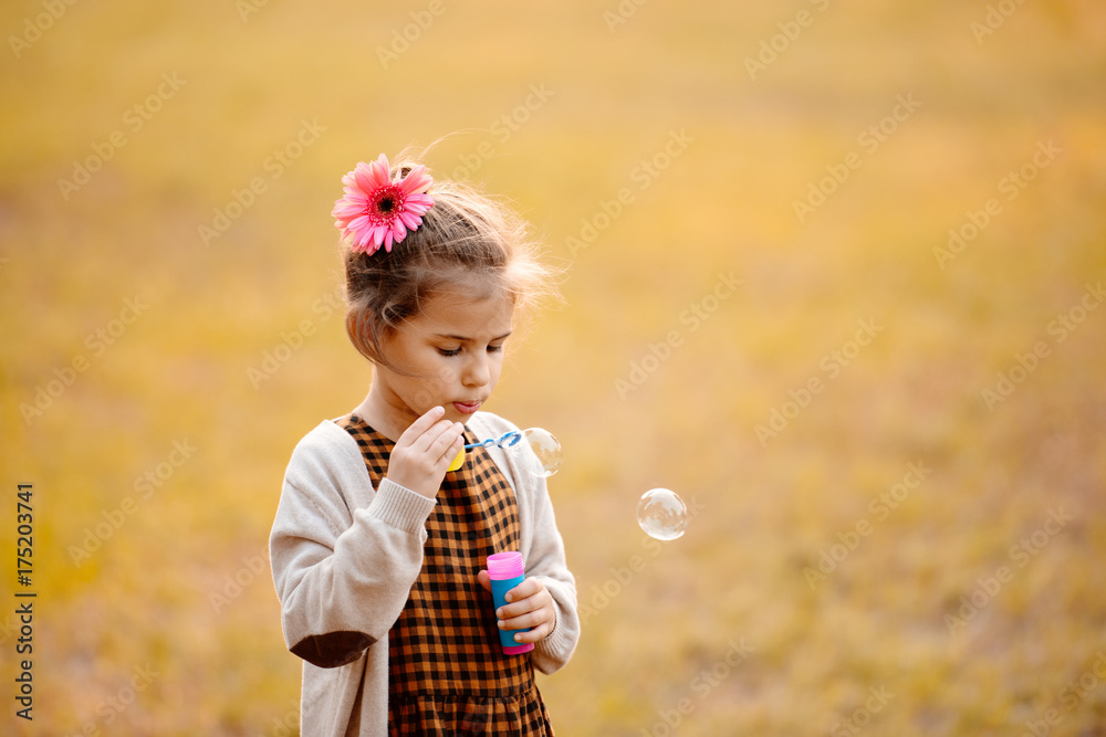 Child blowing soap bubbles