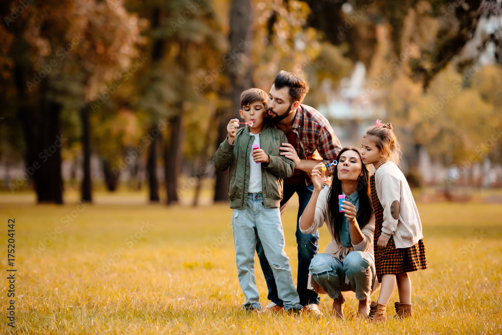 Fototapeta premium Parents with children blowing bubbles