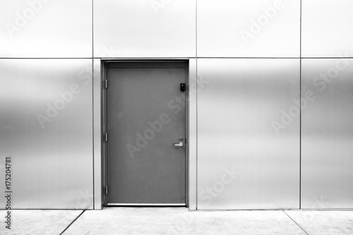 close grey door with aluminium or steel wall